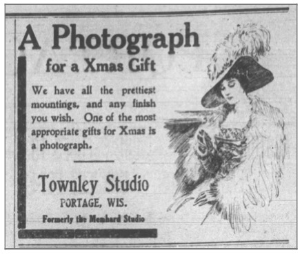 Christmas-Themed ad. in the November 30, 1914 Portage daily register for Townley Studio with a drawing of a woman in a fur and fancy hat.