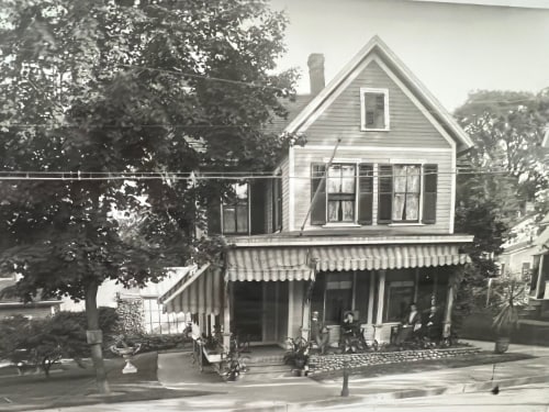 Undated photo showing the Drew home in Ansonia, CT. There are 4 people seated on the porch: L-R are John Drew, Clara Barton, and an unidentified couple. Photo by Clara Barton Drew. Courtesy the Derby Historical Society.