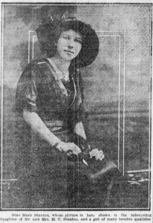 Photo of a teenage Mary Stanton, posed sitting in a hat with flowers in her lap. Springfield News, February 7, 1915