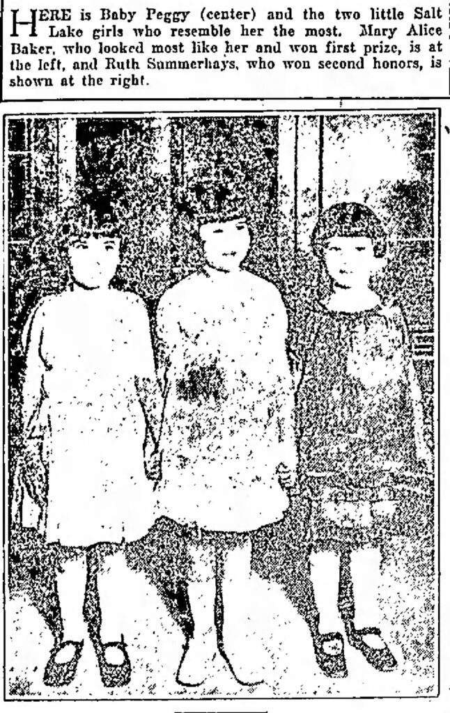 Very washed out photo of the first and second place winners of the Baby Peggy contest, standing with Baby Peggy herself. The scan of the newspaper photo is too washed out to see anything in the photo other than tthe fact that the.3 little girls are all about the same height, are all wearing dresses, and all have short bobbed hair. Salt Lake Telegram, Oct 08, 1924