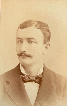 Photo of man with moustache and bow tie. CDV by J. H. Folsom.