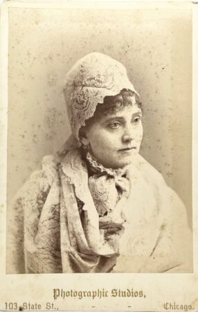Front of cabinet card by Lydia J. Cadwell showing woman draped in a lace shawl and headpiece. (Courtesy McIntyre-Culy Collection)